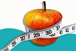 A tape measure wrapped around an apple on a colorful background